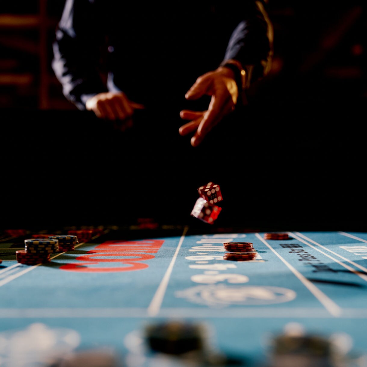 Craps table action with dice and casino chips.